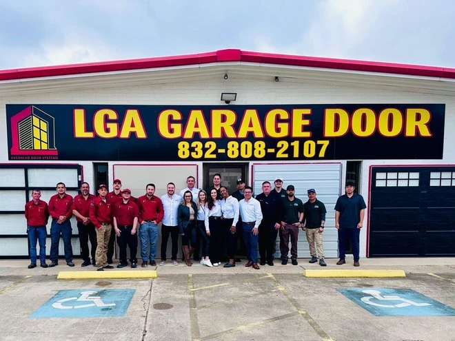 LGA Garage Doors Team photo in front of the building signage