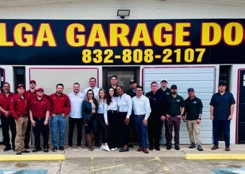 LGA Garage Doors Team photo in front of the building signage