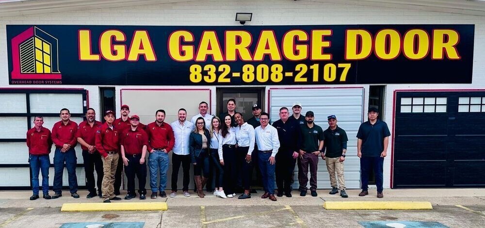 LGA Garage Doors Team photo in front of the building signage